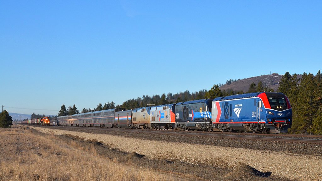 First run: Amtrak no. 8, the eastbound Empire Builder, overtakes a BNSF empty grain train at Moab, Wash. Bruce Kelly photo