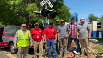 Part of the R.J. Corman team that helped install the new highway/rail grade crossing signals for Safety City, a safety program for second-graders run by the Lexington, Ky., Police Department. From left to right: R.J. Corman Signaling AVP of Engineering Signaling Rocky Metz; R.J. Corman Signaling General Manager Rich Barsalona; R.J. Corman Signaling Senior Systems Engineer Matthew Hamlin; R.J. Corman Railroad Services Signal Specialist Jared Lundy; R.J. Corman Railroad Services Signal Specialist Travis Lundy; R.J. Corman Railroad Services AVP of Signal Construction Larry Yeager; and R.J. Corman Railroad Services Signal Construction Ryan Hale. (Caption and Photograph Courtesy of R.J. Corman)