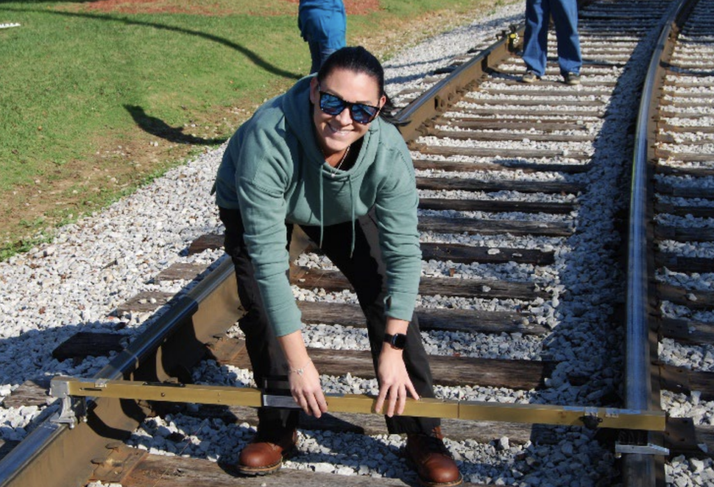 Desiree Miller of Atlantic Railways uses a track gauge to take measurements during a University of Tennessee rail inspection and safety course. Miller received a Doug Golden Scholarship through the ASLRRA Short Line Education Fund to help pay for her training.