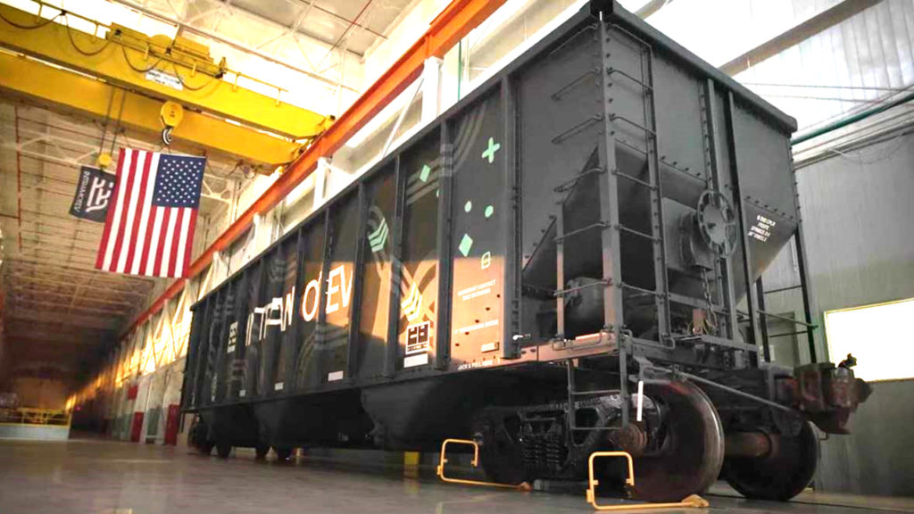 According to Intramotev, its ReVolt cars remain in the train consist “to capture energy via regenerative braking and reduce locomotives’ diesel consumption,” while its TugVolt cars (pictured)—supplied as a “proprietary kit that can retrofit/upfit existing railcars to become battery-electric”—can decouple from the consist to independently provide first- and last-mile service.