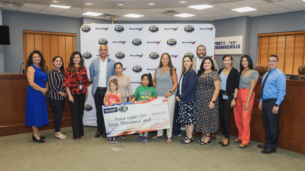 BRG’s $9,000 donation to Point Isabel Independent School District in honor of nine “safe” shipper will provide clothing and school supplies for local students and families impacted by Laguna Heights tornado, according to OmniTRAX. BRG President Shariff Gonnella, pictured fourth from left; Norma Torres, retired BRG leader, pictured sixth from right. (Photograph Courtesy of OmniTRAX)