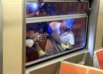 Crews replace windows broken by vandals on Sept. 12. (Marc Hermann / MTA)