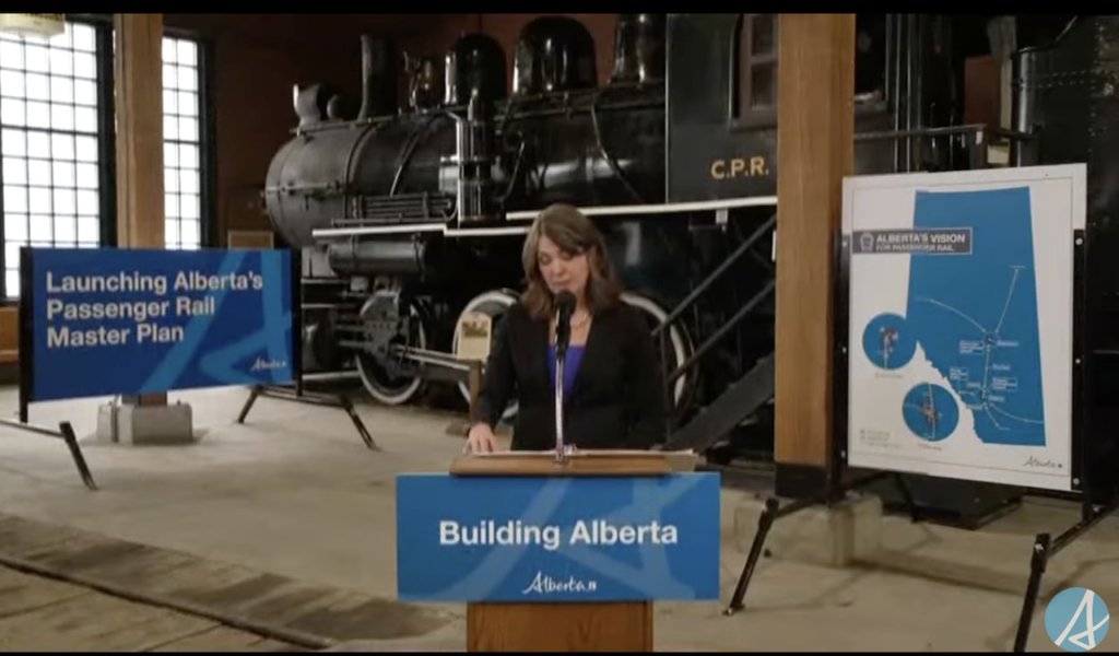 Premier of Alberta Danielle Smith announces the government's master plan aimed at increasing passenger rail service in the province. (Screenshot Courtesy of the Alberta government via YouTube)