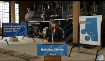 Premier of Alberta Danielle Smith announces the government's master plan aimed at increasing passenger rail service in the province. (Screenshot Courtesy of the Alberta government via YouTube)
