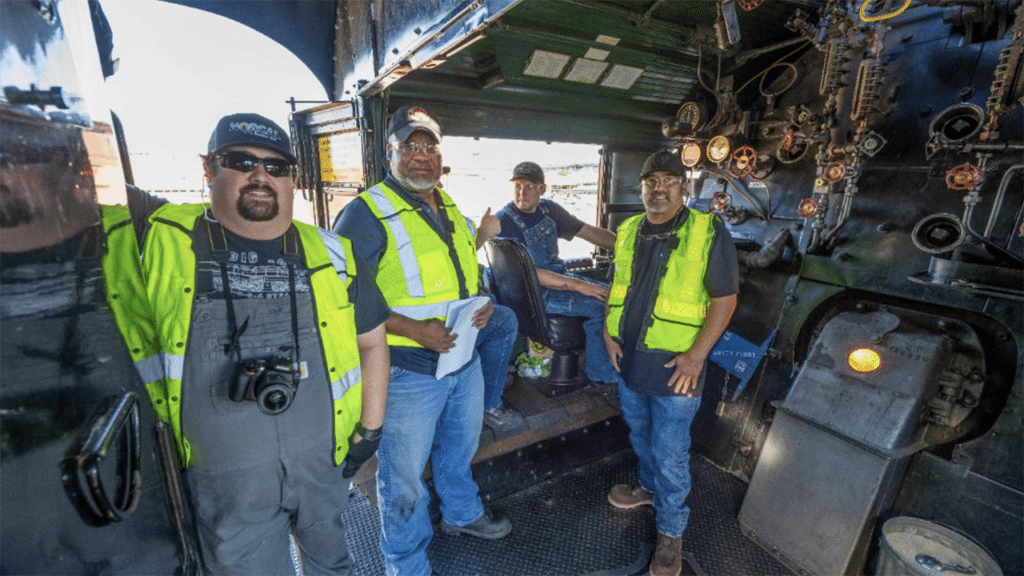 UP craft professionals Ronald Chapman, far left, and Joe Montiel, far right, rode in the cab of No. 4014 on Aug. 28. (Caption and Photograph Courtesy of UP)