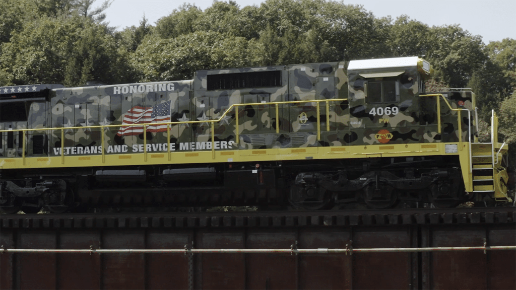 “Today, we are excited to share this video which introduces our new locomotive design scheme honoring veterans and service members, and showcases several of the many veterans who work for G&W,” G&W posted on Facebook and LinkedIn on Veterans Day. (Screenshot of Providence & Worcester 4069 from G&W Video)