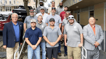 BLET Vice President Randy Fannon (far left) and BLET Special Representative Jorge Gomez (far right) with newly organized members from Florida Gulf & Atlantic in 2023. (Caption and Photograph Courtesy of BLET)
