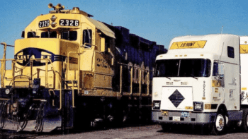 ATSF President Mike Haverty “saw the potential to harness the cost-efficiency of rail transportation with the agility of highway trucking,” JBHT reported. “He invited Mr. Hunt to join him on a train ride to discuss his idea on November 1, 1989 … By the end of their journey, they’d formed an agreement to put J.B. Hunt trailers on the steel highway. A simple handshake marked the beginning of a decades-long strategic alliance that would change the industry forever.” (JBHT Photograph)