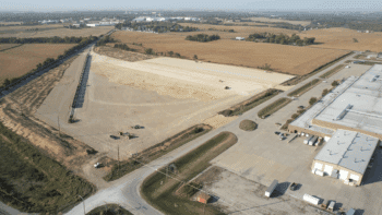 This drone image shows the site of Iowa Interstate Railroad's wind energy component transload facility in Newton, Iowa, while it was under construction. Directly adjacent to the facility is TPI Composites, a wind turbine blade manufacturer. (Caption and Photograph Courtesy of ASLRRA)