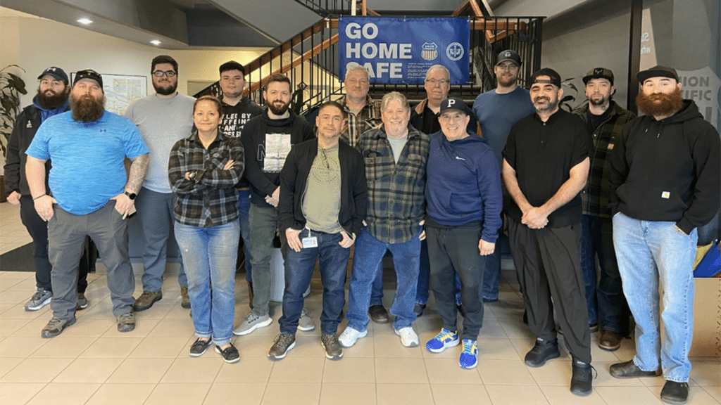 UP’s Pacific Northwest craft professionals celebrate their service unit win: the esteemed Safety Bell, presented annually to the Transportation service unit with the best overall safety record. (UP Photograph)