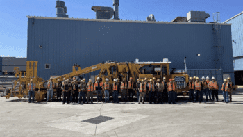 UP’s team of mechanics stands with the 100th rebuilt tamper at its Denver, Colo., shop. The railroad’s maintenance-of-way equipment fleet helps to maintain more than 18,000 miles of track and to compact 4 million tons of ballast each year. (UP Photograph)