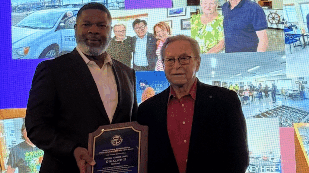 Pacific Harbor Line and President Otis L. Cliatt II (left) received the 2025 Maritime Industry Salute Award on Oct. 2. It was presented by Guy Fox, Chairman of the Board of the International Seafarers Center of the Ports of Long Beach and Los Angeles (right). (Photograph Courtesy of PHL)