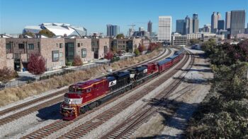 NS Train 955 passing through downtown Atlanta, Ga., on Nov. 13 with the new “Landmark Series” locomotives leading office cars toward Forest Park. The train that evening was part of a charity event in support of Hope Atlanta. (Photograph by NS Locomotive Engineer Casey Thomason, Columbus, Ga., courtesy of NS)