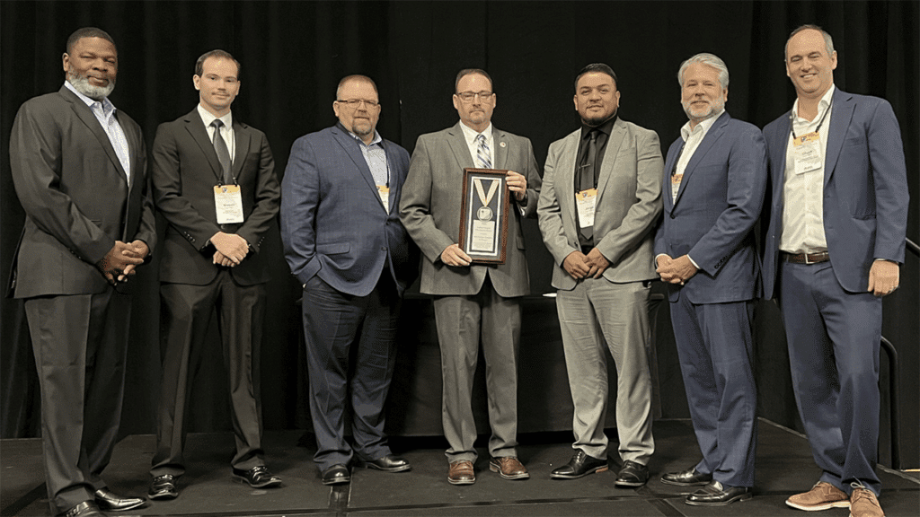 At ASLRRA’s recent Central and Pacific Region Meeting, which included more than 300 attendees, ASLRRA Executive Board Members Otis L. Cliatt II (pictured, left; VP, Pacific Region) and Matthew O. Walsh (second from right; Chair) and ASLRRA President Chuck Baker (right) presented the Belt Railway Company of Chicago with the President’s Award in the “More than 500,000 Person-Hours Worked” category. Accepting the safety award were Junior Software Developer Mason Myre, Assistant Chief Mechanical Officer Robert Perham, Superintendent Jason Charbonneau and Manager of Signals Jorge Guerrero (second through fifth from left, respectively). (Photograph Courtesy of ASLRRA)
