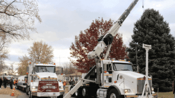 A Union Pacific boom truck and lowboy truck position to transport Omaha’s official Christmas Tree, a 5,500-pound blue spruce donated from the front yard of a metro-area home. (Courtesy of UP)